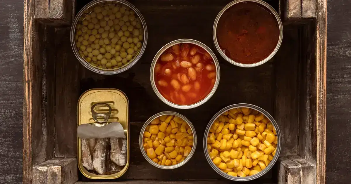 Freeze-dried meal pouches next to tinned food for an emergency reserve