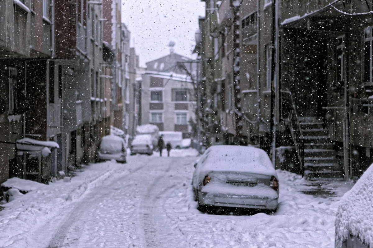 Snowy street with cars during extreme snowfall
