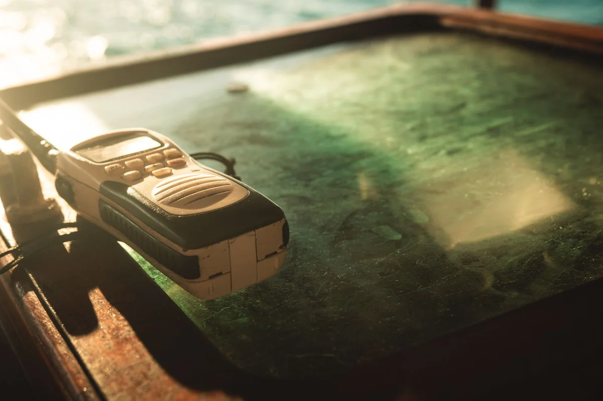 Handheld two-way radio on a table — emergency communication guide covering PMR446 radios
