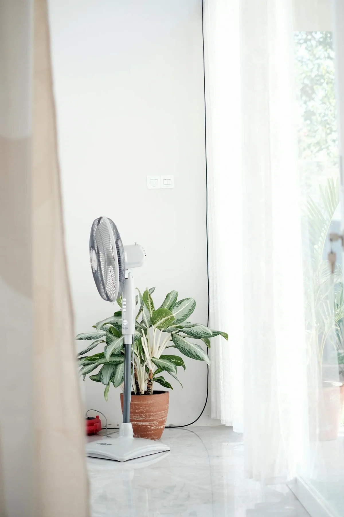 Fan and closed blinds indoors during a heat wave